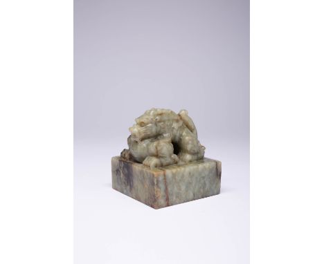 A LARGE CHINESE MOTTLED CELADON JADE 'DRAGON' SEAL QING DYNASTY OR LATER The square-section seal with a crouching horned drag