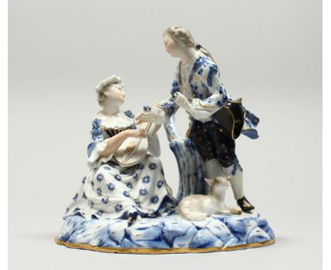 A GOOD MEISSEN PORCELAIN GROUP OF YOUNG LOVERS, a man has a lamb at his feet, a seated lady playing a mandolin, on an oval ba