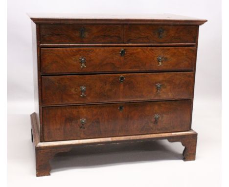AN 18TH CENTURY WALNUT STRAIGHT FRONT CHEST with cross banded and oval inlaid legs, 2 short and 3 long graduated drawers on b