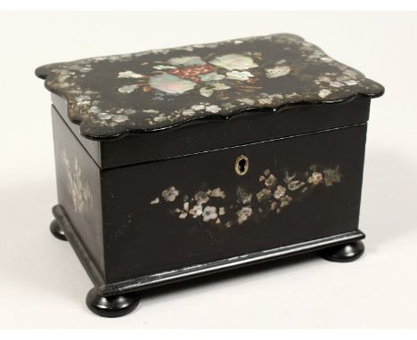 A GOOD VICTORIAN BLACK PAPIER MACHE TWO DIVISION TEA CADDY inlaid with mother of pearl on bun feet. 7.5ins wide.