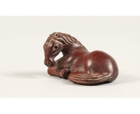 A JAPANESE CARVED WOOD HORSE NETSUKE Signed