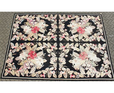 A LARGE ABUSSON STYLE TAPESTRY WALL HANGING, black ground, with floral decoration. 14ft 2ins x 10ft.