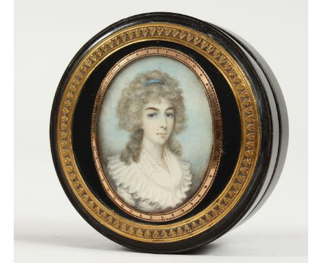 A GEORGIAN EBONY CIRCULAR BOX, the top painted with a portrait of a young lady in a white lace dress. 3ins diameter.