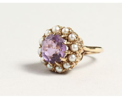 A GOLD CIRCULAR AMETHYST AND PERAL CLUSTER RING