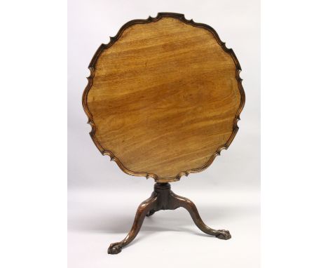 A CHIPPENDALE STYLE MAHOGANY TILT TOP TABLE with pie crust top, turned support, curving legs with claw feet. 2ft 10ins diamet