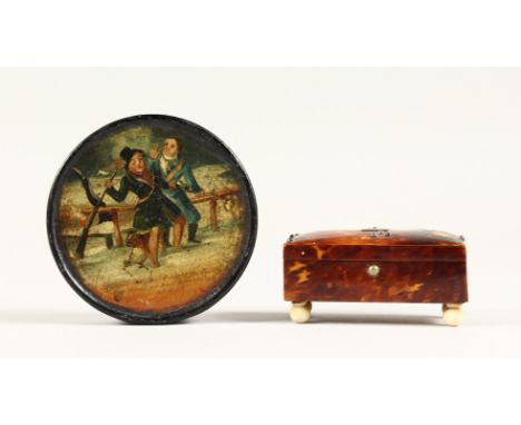 A SMALL TORTOISESHELL CASKET on ivory bun feet and a circular papier mache snuff box. 3ins (2)