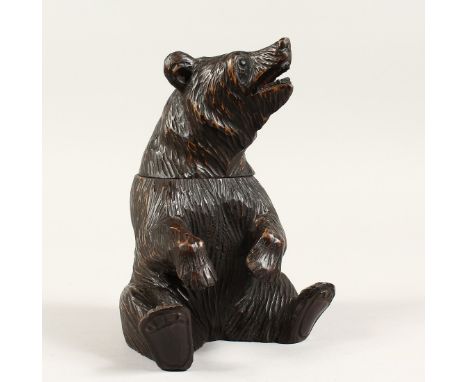 A BLACK FOREST CARVED WOOD BEAR CADDY. 8ins high.