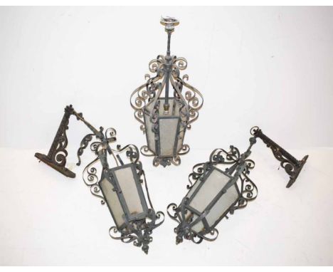 Two wrought iron bracket lanterns and one pendant lantern. With curlicue metalwork. Unfortunately we are unable to do conditi