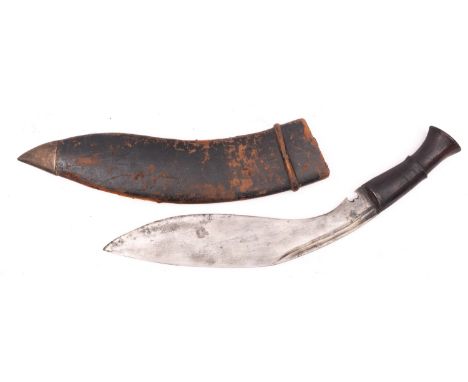 A late 19th/early 20th century Kukri with later markings, the blade stamped with broad arrow and numbered '10 17', over woode