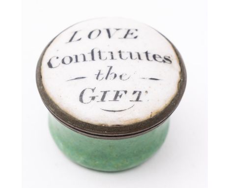 An early 19th century circular enamel patch box 'Love Continues the Gift', black text on white enamel over a green body, 2.3c
