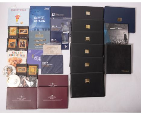 A box containing modern United Kingdom coin sets and Westminster commemorative coin covers, with famous artwork plaques, £20 