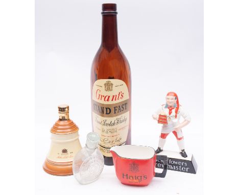 A Carltonware advertising figure 'Pick Flowers Brewmaster', together with a 'Haig's Whisky ' water jug and empty Bell's Whisk