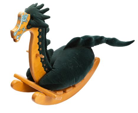 A 20th century American beech rocking dragon, the shaped beech ladder frame  with painted face and green plush  horns, mane a