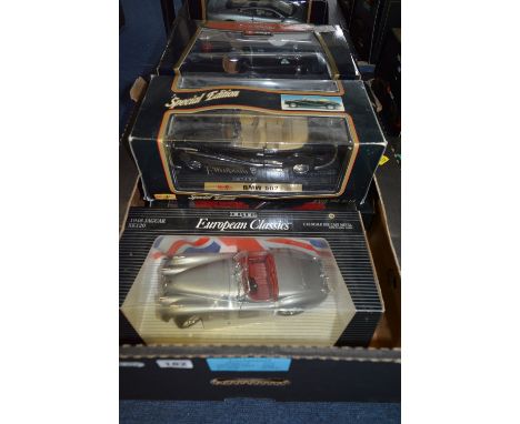 A COLLECTION OF FIVE BOXED 1:18 SCALE MODEL DIECAST CARS, manufactured by Burago, Maisto, ERTL & Mattel. Models are European 