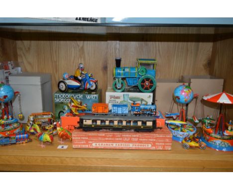 A COLLECTION OF BOXED AND UNBOXED MODERN TINPLATE TOYS, and Christmas decorations, to include clockwork fairground rides, mot