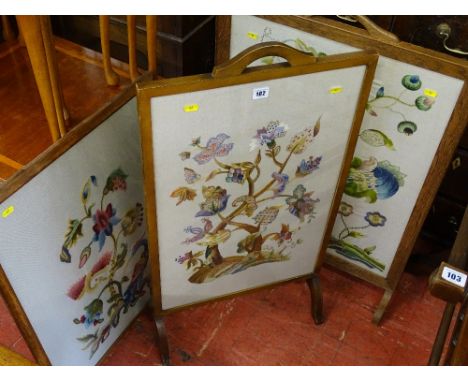 Two oak framed tapestry firescreens and a similar oak framed hanging