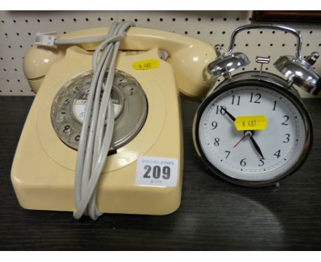 Vintage telephone and a modern alarm clock