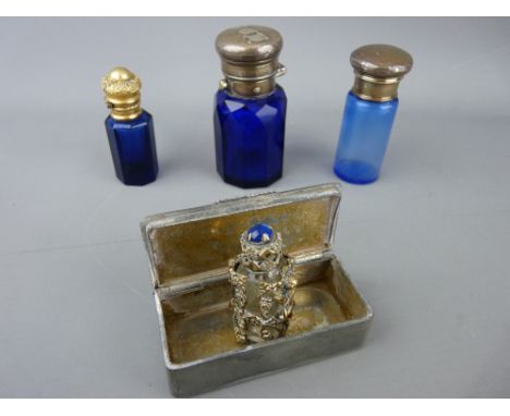 Three Bristol blue smelling salts bottles, various metal tops, small cherub cased example in clear glass and a vintage pewter