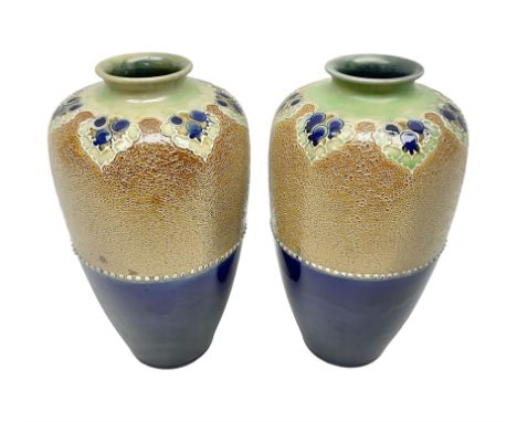 Pair of Royal Doulton Lambeth stoneware baluster vases, decorated in light relief with foliage, impressed mark beneath, H23cm