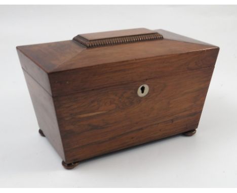 A 19th century rosewood sarcophagus shaped tea caddy, the interior now lined in material, raised on oblate bun feet, width 10
