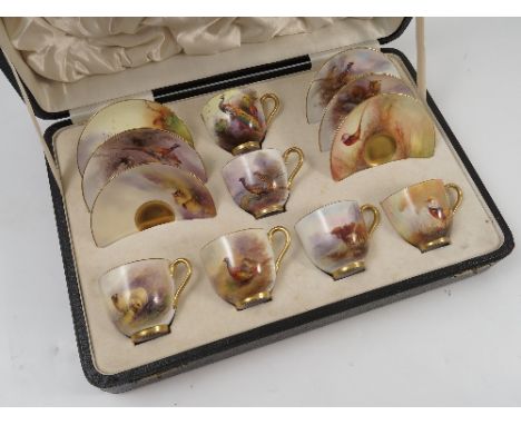 A cased Royal Worcester coffee set, comprising six coffee cups and saucers, hand painted with pheasants, peacocks, Highland c