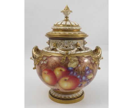 A Royal Worcester covered bow vase, hand painted with fruit to a mossy background by Freeman, with pierced neck, gilt handles