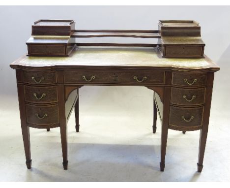 A 19th century mahogany desk, with leather inset top and being profusely inlaid with cherubs and garlands of flowers, the top