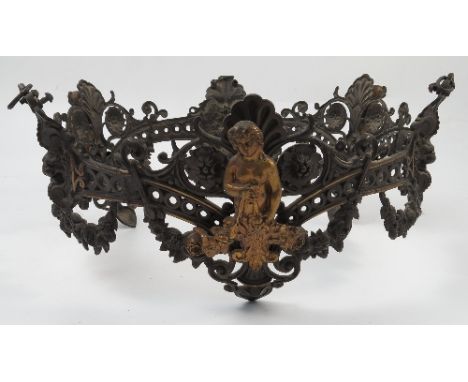 A pressed metal light fitting, of circular form, with pierced and embossed decoration of Classical motifs, with scrolls, swag