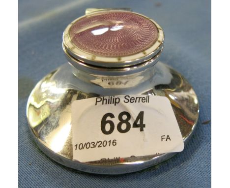 A small silver inkwell, the circular cover having enamel and guilloche decoration, with glass liner, Birmingham, 1909, width 