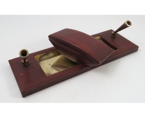 An Asprey London red leather covered desk set, comprising rectangular tray with well and two pen holders and a blotter