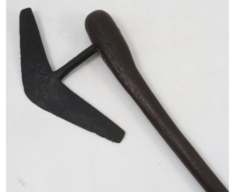 A tribal war axe, with wooden handle and steel angular blade, length 26.5ins