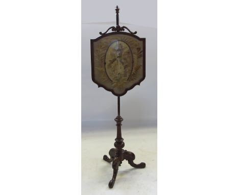 A 19th century walnut pole screen, with needlework tapestry panel, raised on a tripod base, height 59ins 