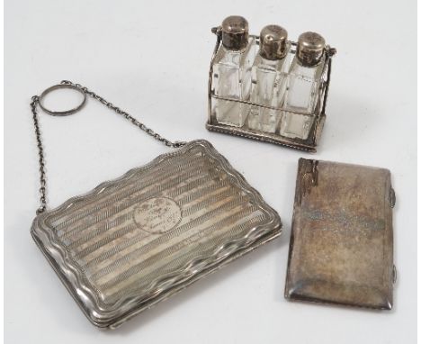 A silver ladies purse, with engine turned decoration and inscription, with leather interior, with chain handle and finger rin