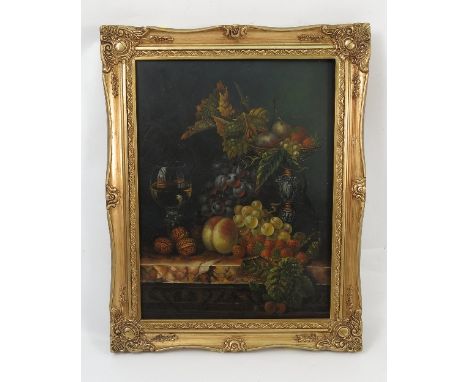 An oil on wooden panel, still life study of fruit and leaves with walnuts, glass and comport on a marble shelf, 15.5ins x 11.