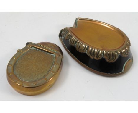 A novelty vesta case, formed as a horses hoof, with black enamel wall, brass feather and shoe, together with another novelty 