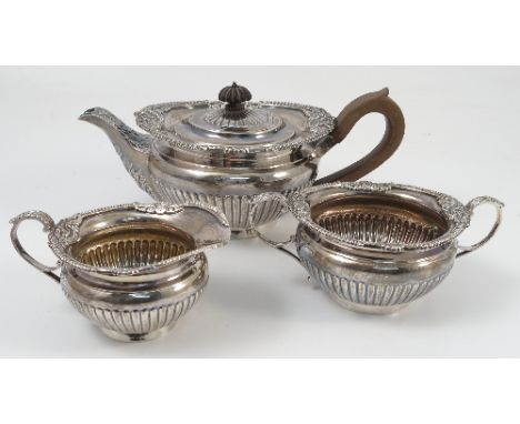 A Victorian silver three piece tea set, with gadrooned and shell border, to a gadrooned lower body, London 1895, maker Thomas