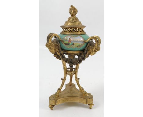 A 19th century enamel and ormolu covered urn, the pierced ormolu cover with flame finial resting on a pierced neck, the green