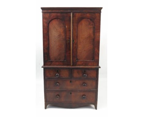 A 19th century miniature mahogany linen press, with two arched panel doors, opening to reveal three slide out trays, fitted w