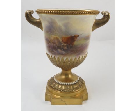 A Royal Worcester two handled urn, hand painted to the front with Highland cattle in a landscape, by John Stinton, with gilt 