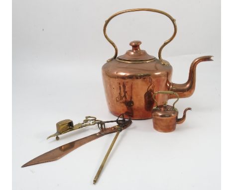 A collection of Antique brass, copper and iron fire side implements, to include a kettle and miniature kettle, poker, wall mo