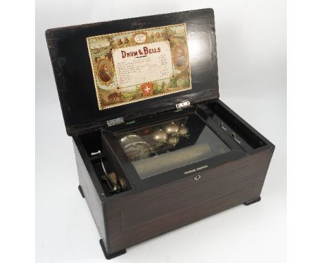 A 19th century musical box, playing ten airs, the interior of the lid bearing paper label, having hinged glazed lid revealing
