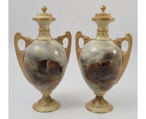 A pair of Royal Worcester twin handled covered vases, both hand painted with two Highland cattle in a landscape by John Stint