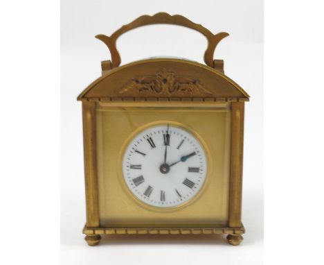 A brass cased carriage clock, of rectangular form with domed top, with circular white enamel dial and Roman numerals, height 