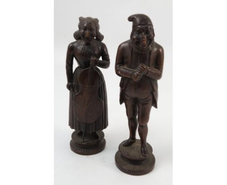 A pair of 19th century treen nutcrackers, formed as an old man and a woman holding a cello, with screw action from the waist,