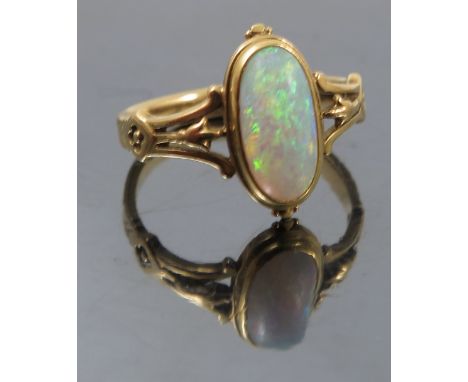 A late Victorian single stone opal ring, to a Gothic style mount, finger size K1/2, weight 3.1g gross, cased 