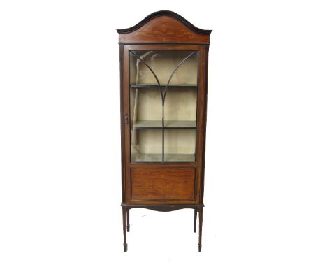 A 19th century mahogany display cabinet, with astragal glazed door opening to reveal shelves, below the arched pediment and f