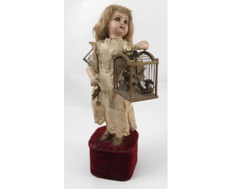 A late 19th century bisque socket head doll automaton, marked to the back of the head in red `Deposse Tete Jumeau 4', with fi