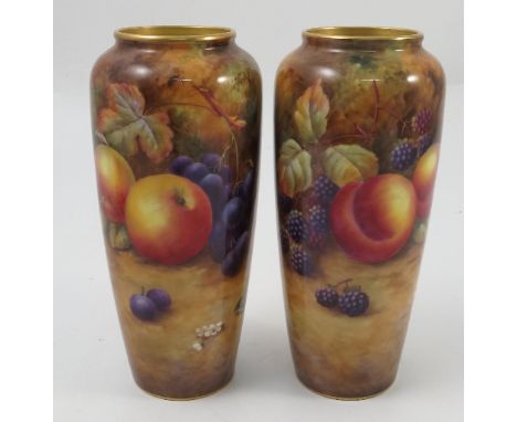 A pair of Royal Worcester vases, decorated all around with hand painted fruit to a mossy background by H Price, shape number 