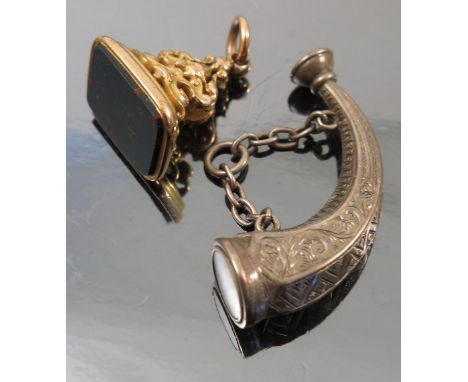 A novelty watch fob, in the form of a hunting horn, with a compass mounted to one end, length 4cm, together with a bloodstone