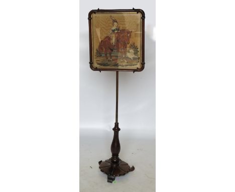 A 19th century pole screen, with rectangular tapestry panel, with part turned column to circular base with three knurl feet